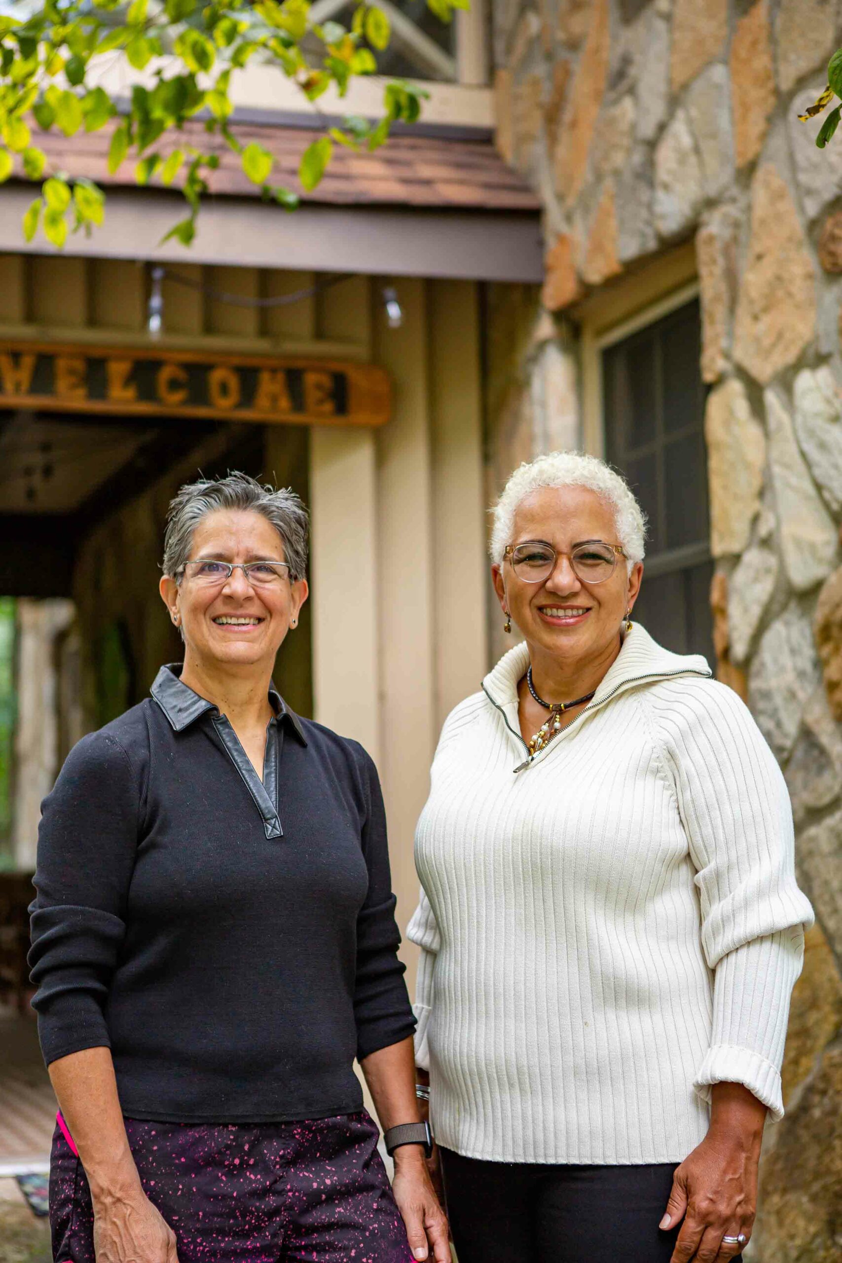 Two women pose for the camera, smiling