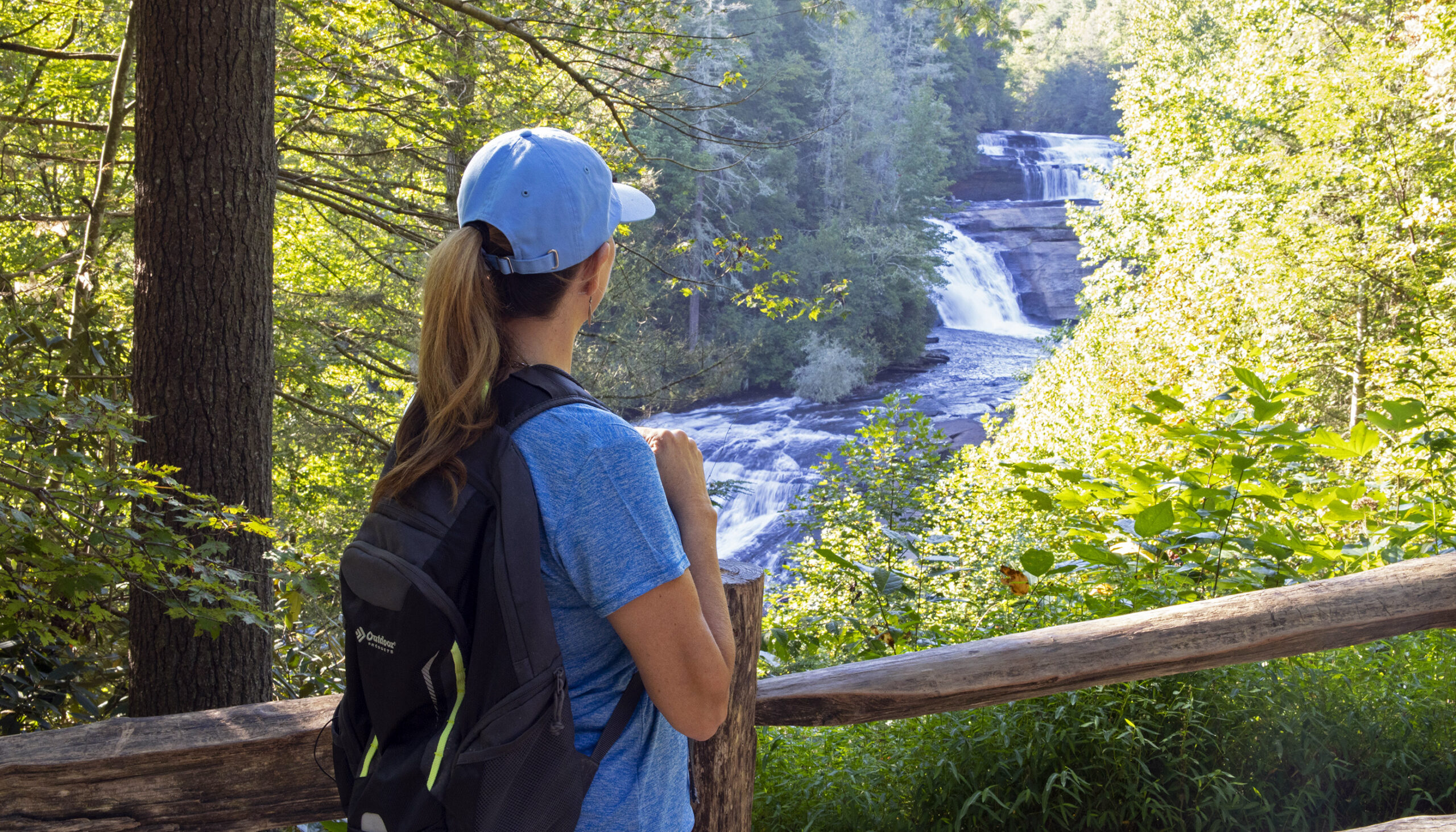 woman looking at waterfall