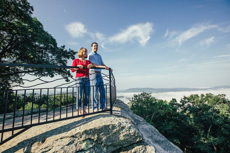 couple looking out at mountain views from scenic overlook