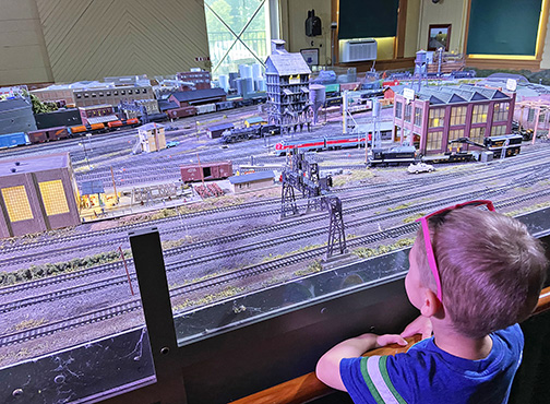 boy watching model trains